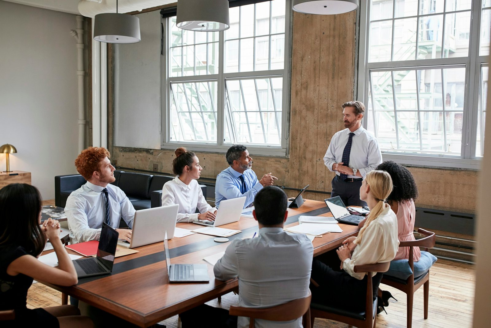 Bearded businessman addressing colleagues at a board meeting