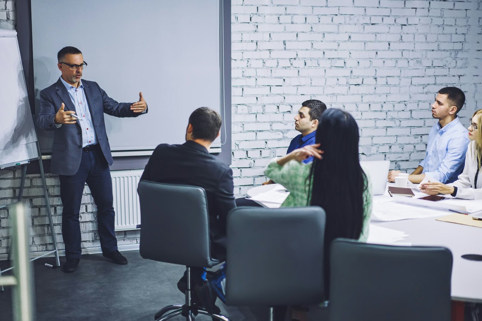 mature executive manager sharing experience information during brainstorming in firm